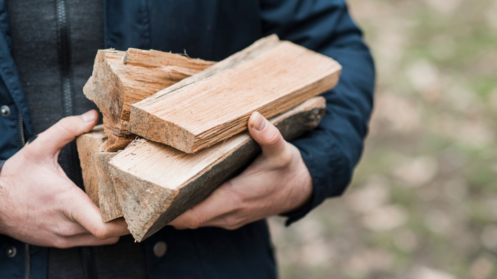 close up man carrying wood